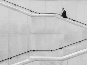business owner walking up stairs black and white
